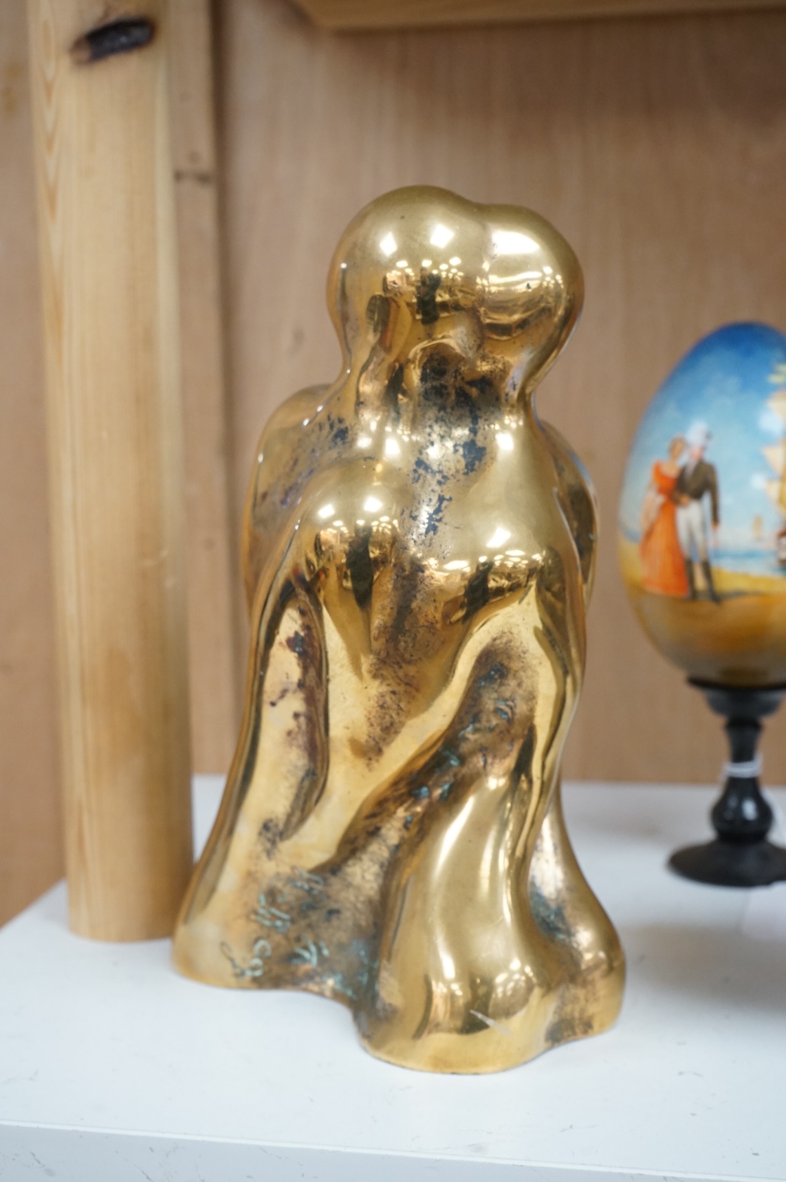 A modernist polished bronze sculpture, two entwined figures, indistinctly signed, 23cm high